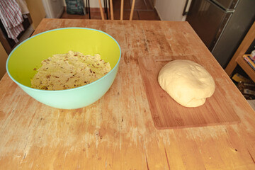 Polish dumplings (pierogi ruskie) ingredients - dough, cheese, potatoes and onion in bowl