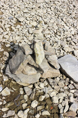 Rock balancing (or stone balancing) figure on lake shore
