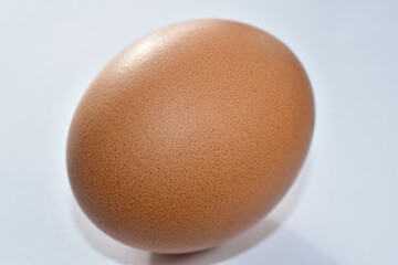 Close-up shot of a chicken egg on the table.