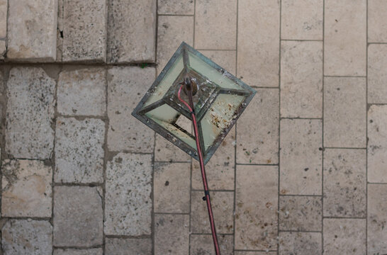 Dirty lamp post covered in pigeon poo in the streets of Dubrovnik Old Town