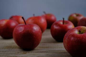 REd apples are on the wooden table