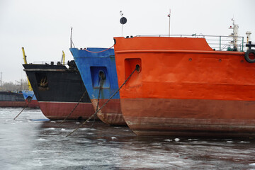 Wintering of ships on a frozen river. Old rusty motor ship. Volgograd. Krasnoarmeisky Zaton.