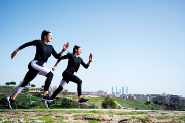 Fototapeta na wymiar two women running side view