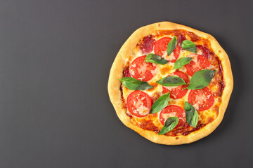 Pizza with cheese, sausage and tomatoes