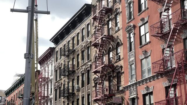 tenement building with fire escapes in Chinatown New York City NYC