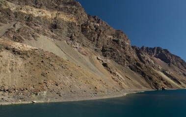 Alpine landscape. The glacier water lake in the cordillera in a summer sunny day. View of the turquoise color lake called Inca Lagoon high in the Andes mountain range in Portillo, Chile.