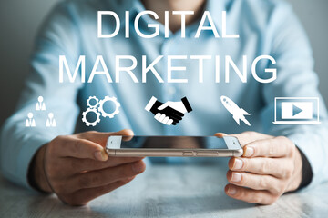 man holding phone with digital marketing icon.