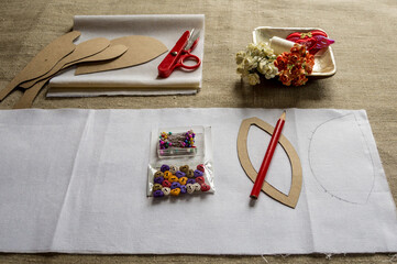 Fabric and patterns are laid out on the desktop. Needlework, hobbies, creativity.