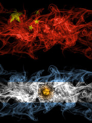 China, Chinese vs Argentina, Argentinian, Argentine smoky mystic flags placed side by side. Thick colored silky abstract smoke flags.