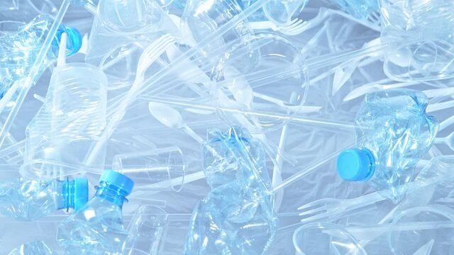 Super Slow Motion Shot of Exploding Plastic Trash on Light Blue Gradient Background at 1000fps.