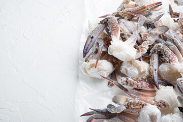 Frozen raw blue swimming crab claws, on white background  , with copyspace  and space for text