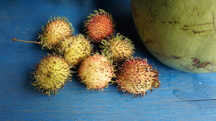 rambutan and a coconut from a swimming market in Can Tho, Mekong Delta, Vietnam, January