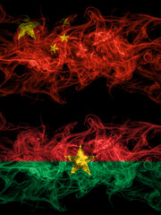 China, Chinese vs Burkina Faso, Burkinese smoky mystic flags placed side by side. Thick colored silky abstract smoke flags.