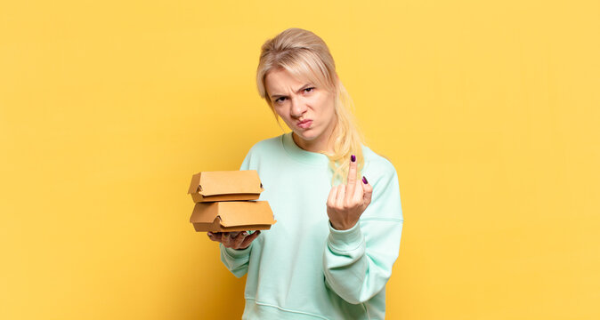 Blonde Woman Feeling Angry, Annoyed, Rebellious And Aggressive, Flipping The Middle Finger, Fighting Back