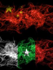 China, Chinese vs Casamance, Senegal  smoky mystic flags placed side by side. Thick colored silky abstract smoke flags.