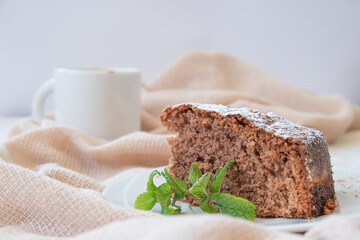 Chocolate cake with a coffee from an Austrian restaurant. White background with a brown tea towel Concept: cake and coffee.