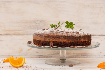 Homemade chocolate and orange cake, with powdered sugar to decorate.
