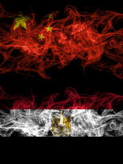 China, Chinese vs Egypt, Egyptian smoky mystic flags placed side by side. Thick colored silky abstract smoke flags.