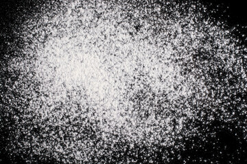 Flour on a black background. Abstract background.