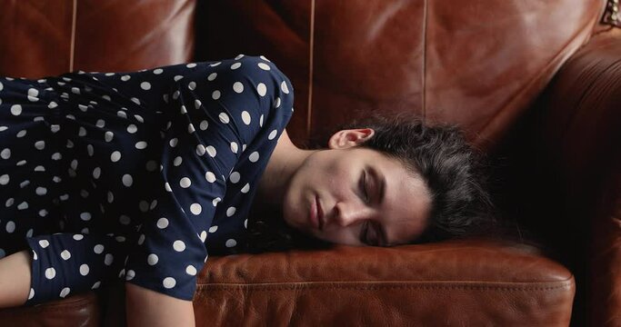 Close up view sofa on which tired female plopped down. Low energy level due unhealthy diet, insomnia, need vitamin complex, medical check up in clinic, overload businesslady necessary vacation concept