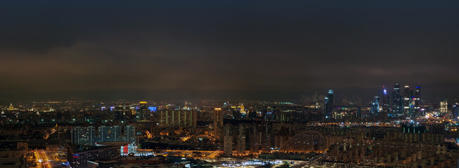 Panoramic aerial view of night Moscow, Russia. Moscow City skyscrapers at night, skyline. City landscape in Russia