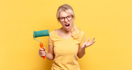 blonde woman looking angry, annoyed and frustrated screaming wtf or what’s wrong with you