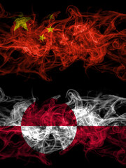 China, Chinese vs Greenland, Denmark, Danish smoky mystic flags placed side by side. Thick colored silky abstract smoke flags.