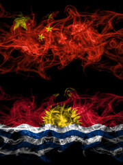 China, Chinese vs Kiribati smoky mystic flags placed side by side. Thick colored silky abstract smoke flags.