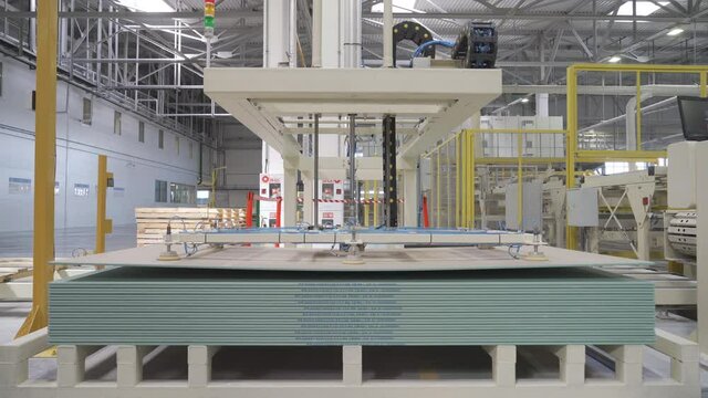 Gypsum board conveyor. Plasterboard plant. Factory or workshop manufacture of drywall, plasterboard sheets