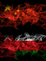 China, Chinese vs Oman smoky mystic flags placed side by side. Thick colored silky abstract smoke flags.