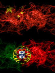 China, Chinese vs Portugal, Portuguese smoky mystic flags placed side by side. Thick colored silky abstract smoke flags.