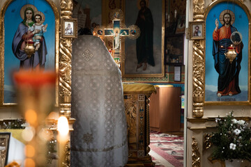 Interior of an Orthodox Ukrainian church. The priest prepares for the ceremony of the Sacrament of...