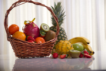 Assorted fruits such as pineapple, dragon fruit, strawberries, kiwi, oranges, tangerines, bananas and apples.