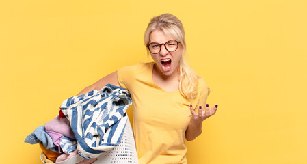 blonde woman looking angry, annoyed and frustrated screaming wtf or what’s wrong with you