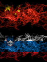 China, Chinese vs Slovenia, Slovenian smoky mystic flags placed side by side. Thick colored silky abstract smoke flags.