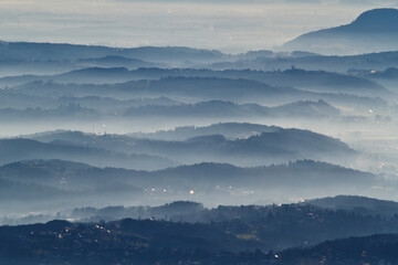Fototapeta na wymiar Dust, smoke and smog in the air above a hill landscape around Graz in Austria