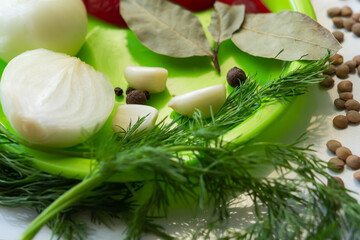 Ingredients for lentil soup. Red bell peppers, lentils, onions,garlic, spices and tomatoes on the table in a green plate top view. The cooking process. The layout of the products. Vegetarian diet soup