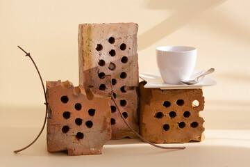 Trendy still life with old bricks, dry plants and a cup of coffee. The use of recycled items in modern living space.  Zero Waste Principle