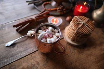 cup of hot cocoa with marshmallows, candles, gifts, sweets, concept of merry christmas, cozy winter mood, holiday