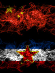 China, Chinese vs Yugoslavia, Yugoslavian smoky mystic flags placed side by side. Thick colored silky abstract smoke flags.