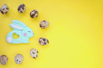 Banner for text with Easter bunny and quail eggs. Top view on a yellow background. Easter. Copyspace.