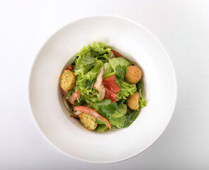 potato balls with cucumber on a white plate 