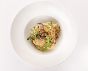 dumplings with mushrooms and hand on a white plate 