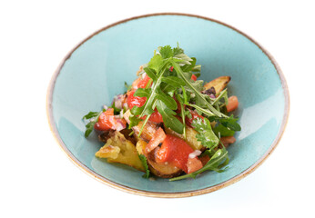 vegetable salad with tomatoes and herbs on a white plate 