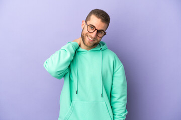 Young handsome caucasian man isolated on purple background laughing