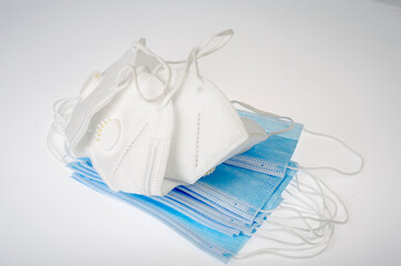 Blue medical disposable masks and white respirators - protection against coronavirus