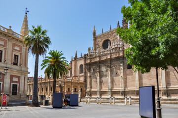 Fototapeta na wymiar Archive Of The Indies (Archivo General de Indias) and Seville cathedral on Triumph square, Spain