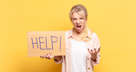 blonde woman looking angry, annoyed and frustrated screaming wtf or what’s wrong with you