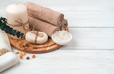 Spa care kit with a branch of eucalyptus on a white wooden background. Side view, horizontal. Cleaning agents.