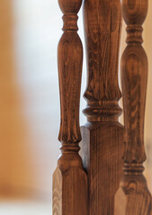 Balusters on a wooden staircase, close-up, shallow depth of field.